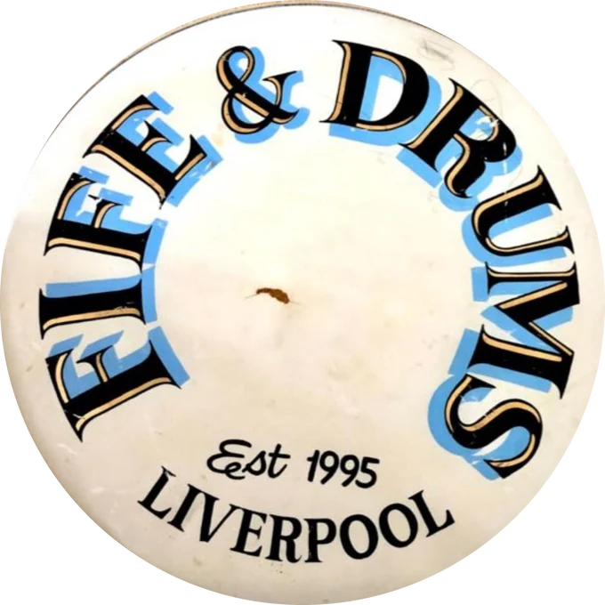 A bass drum head hand-painted with the words Fife and Drums, established 1995, Liverpool.
